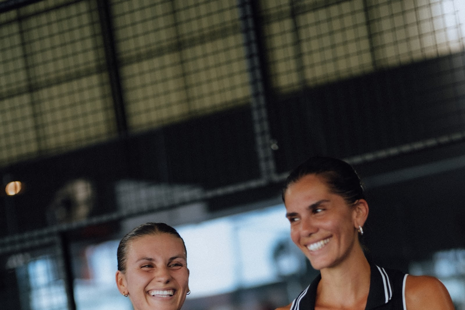 Two members standing together after playing padel at Azoria Uluwatu on a Bali padel retreat