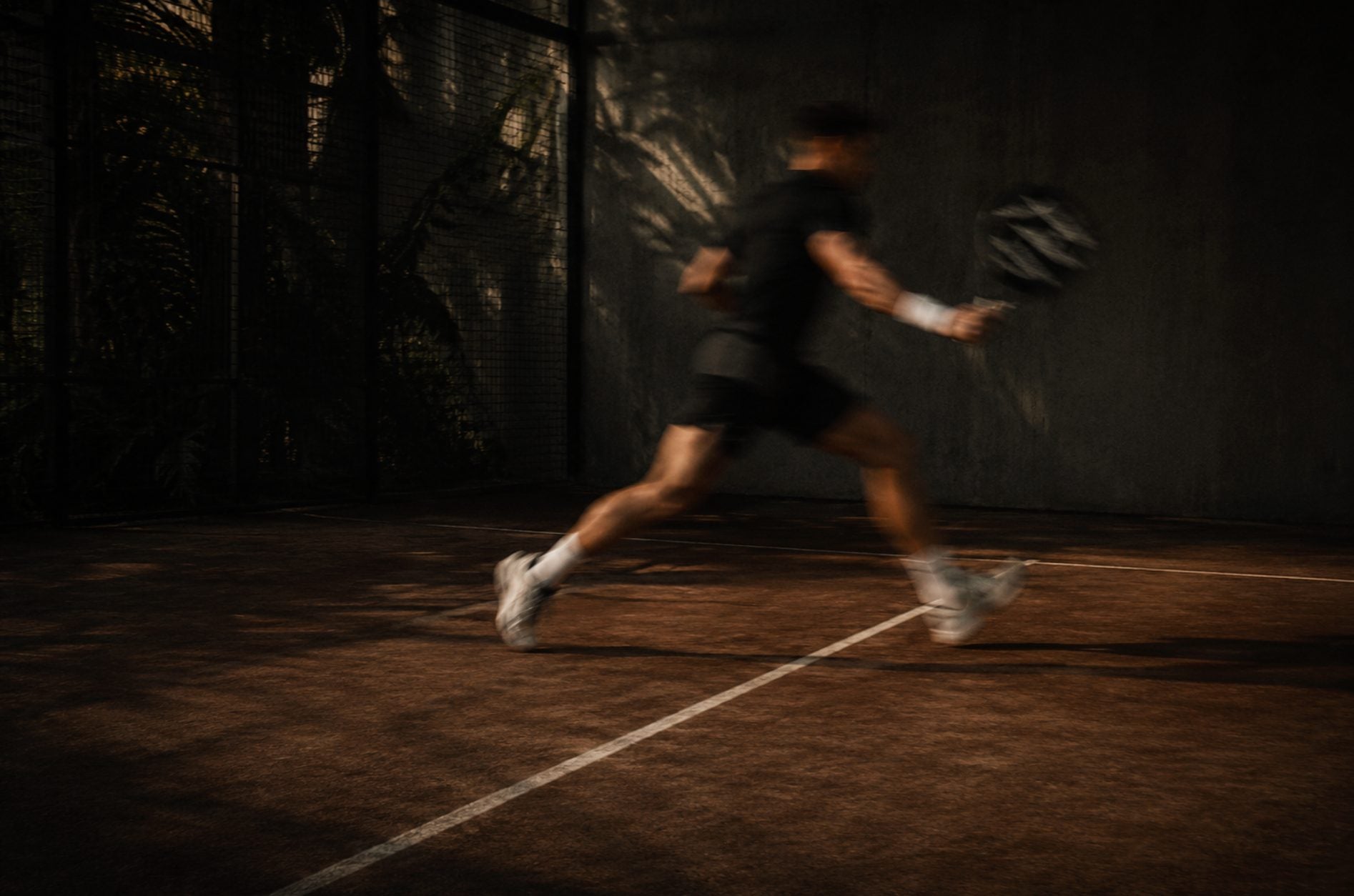 Padel player sprint motion blur — Azoria, Uluwatu, Bali