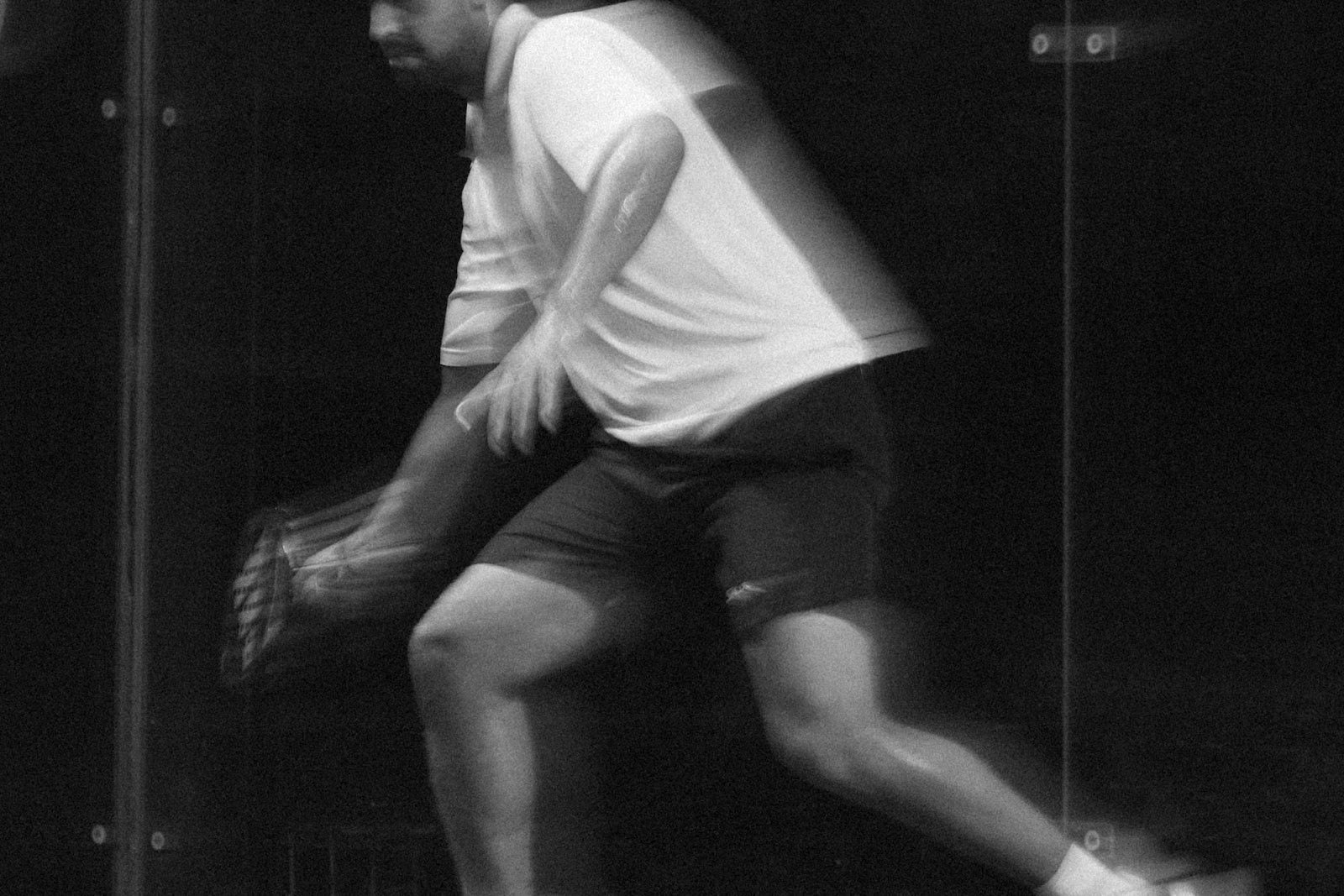 Padel player lunging low in a sprint across the court at Azoria Uluwatu